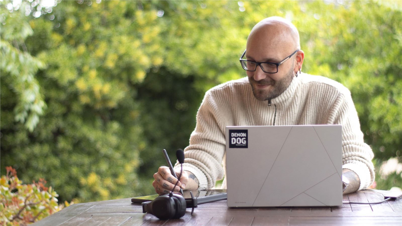 Björn working outdoors with a laptop, headset, and drawing tablet