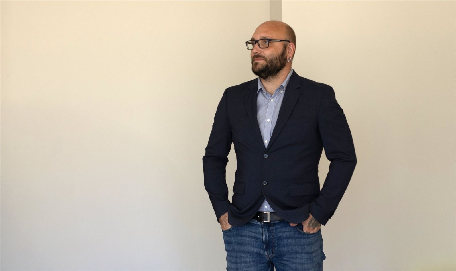 Björn standing in a blazer against a simple wall
